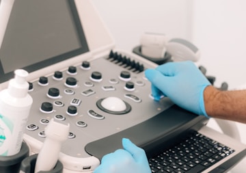 a person in blue gloves is operating a machine