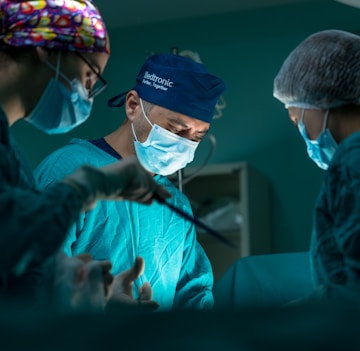 a group of doctors performing surgery in an operating room