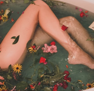 bathtub with water and flowers