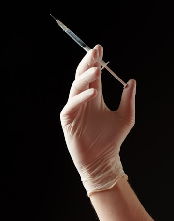 a hand holding a needle