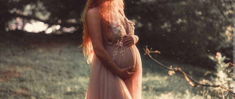 pregnant woman near tree