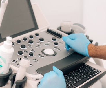 a person in blue gloves is operating a machine