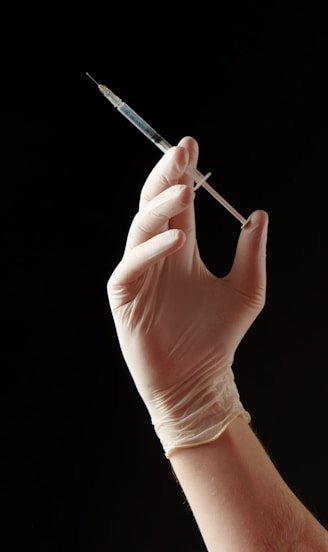 a hand holding a needle