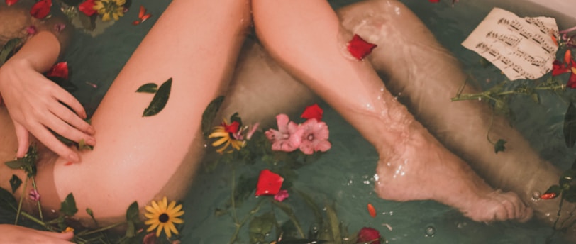 bathtub with water and flowers
