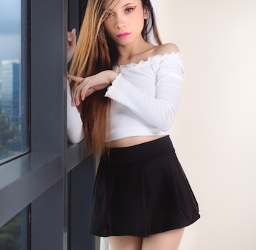 woman in white long sleeve shirt and black skirt